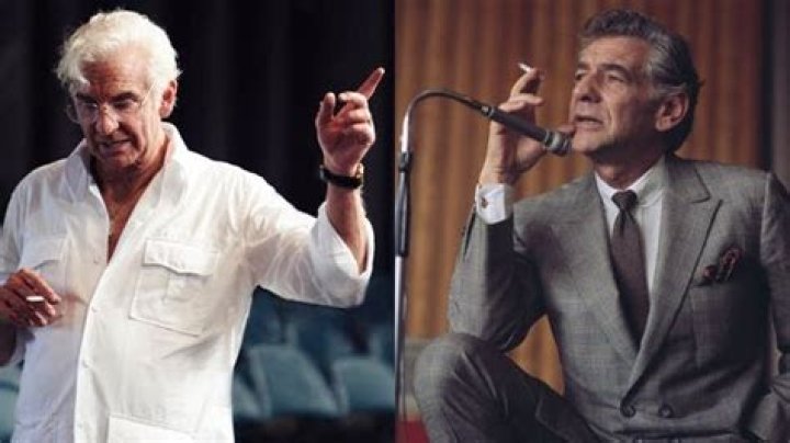 Bradley Cooper as Leonard Bernstein conducting in a tuxedo in Maestro