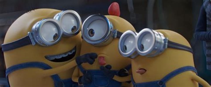 three minions huddled together and making funny faces